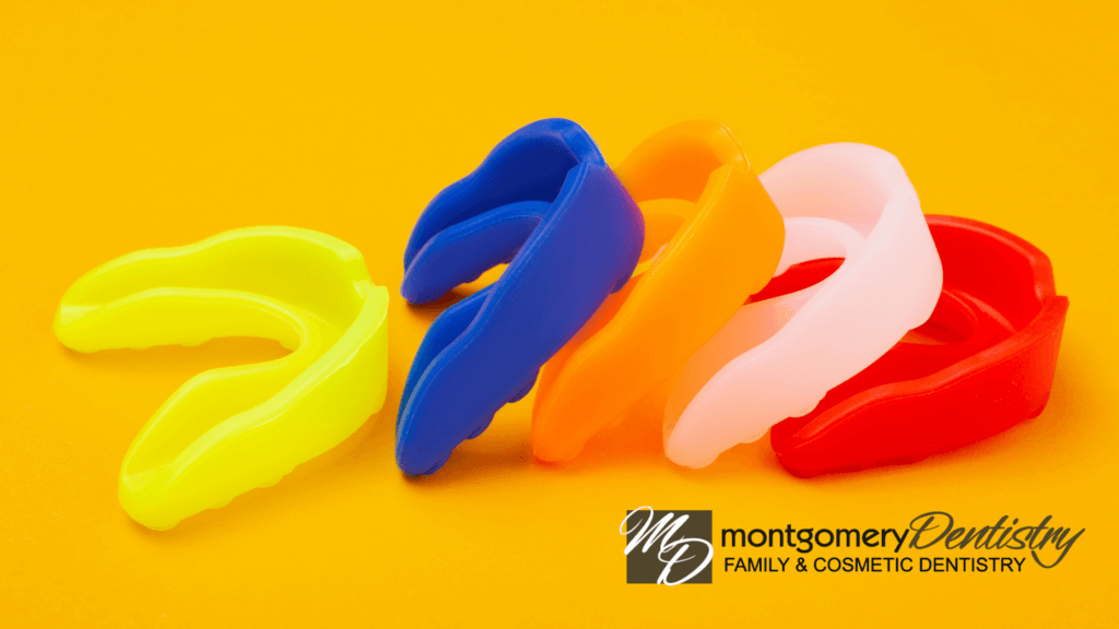 a row of brightly colored sports mouthguards on an orange background